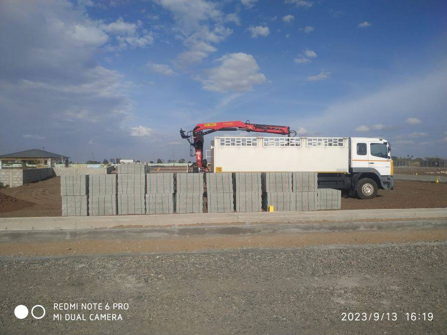 APCO delivery truck unloading blocks at construction site